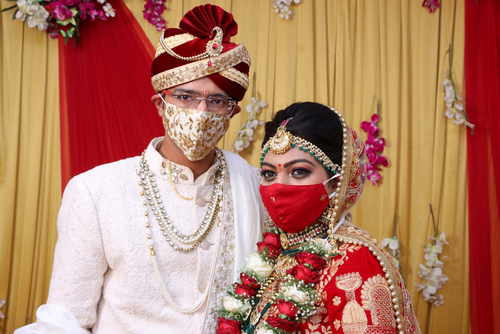 Two people getting married in India wearing face masks
